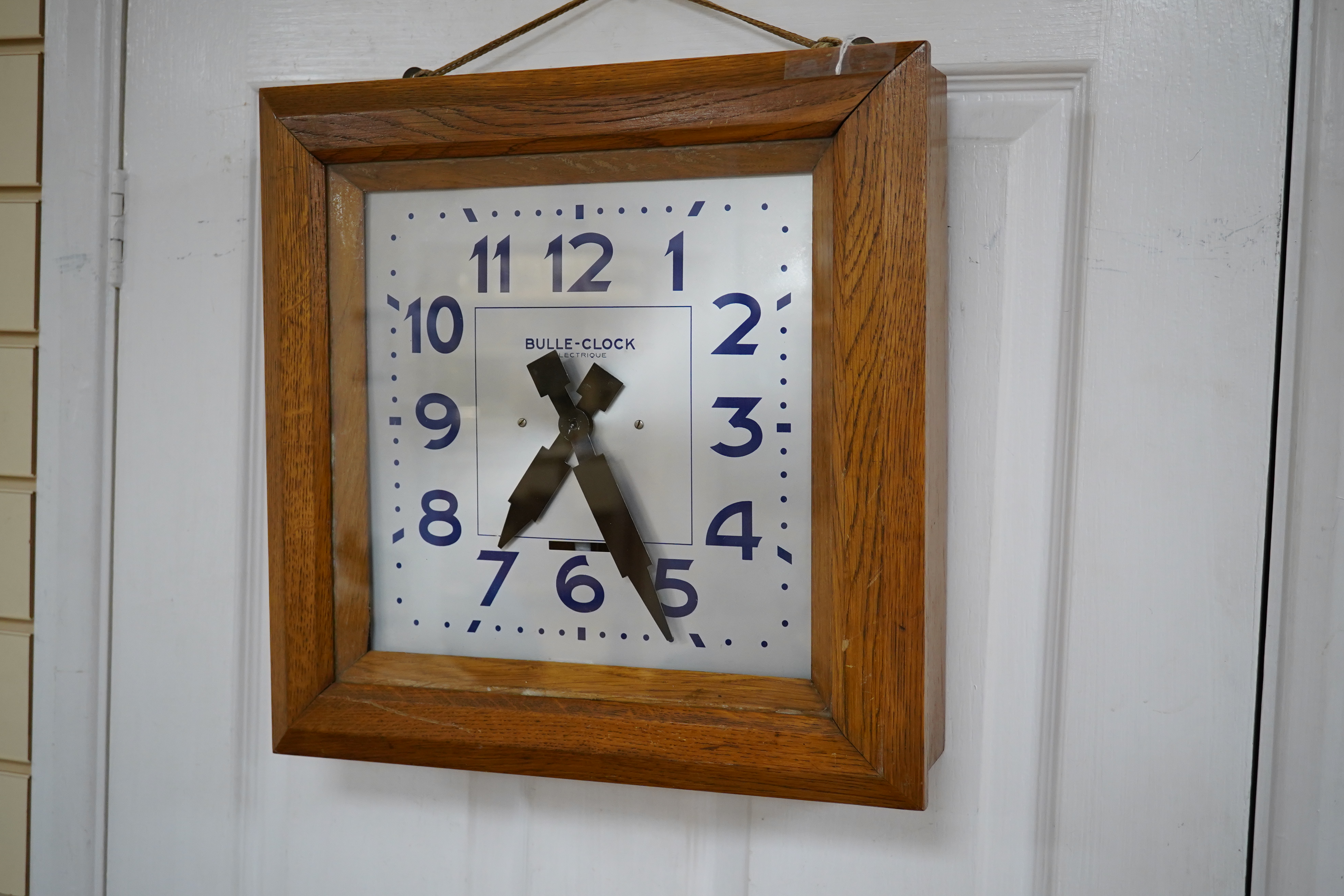 An early 20th century French Art Deco Bulle Electrique oak wall clock, 39cm squared. Condition - scratch to oak on front cover, not checked if working